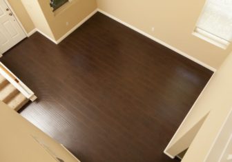 42909024 - beautiful newly installed brown laminate flooring and baseboards in home.