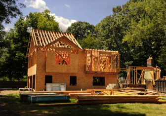 A residential home under construction mid framing and sheathing
